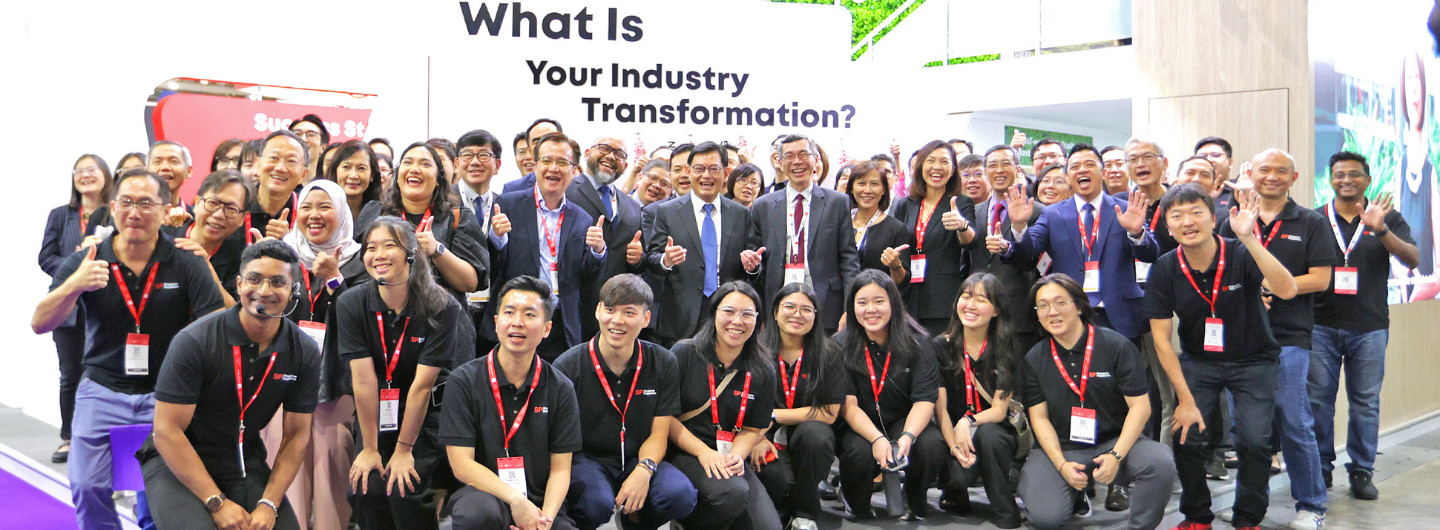 Large group poses with "What Is Your Industry Transformation?" text. Many wear SP Digital branded shirts.